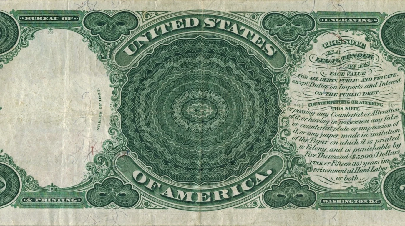 Close-up of the green engraved back of a 1907 United States five-dollar note.
