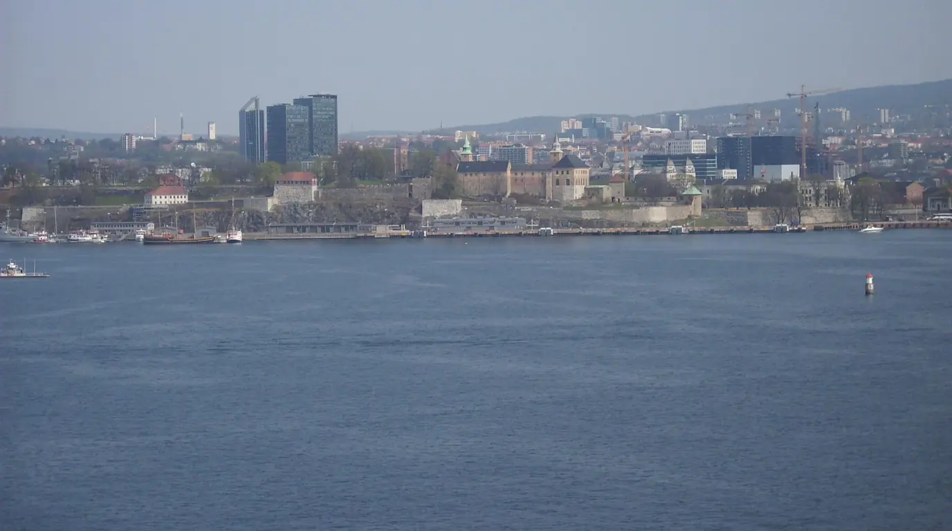 Oslo seen from the fjord, with the old fortress walls on the shoreline and office towers behind